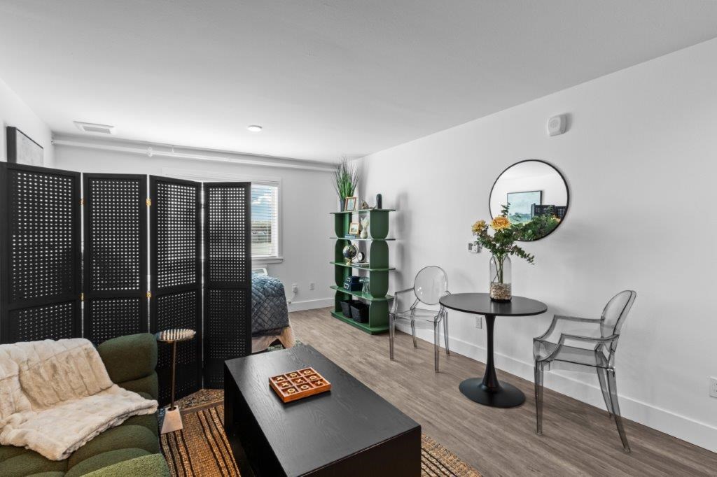 a living room with a table and chairs and